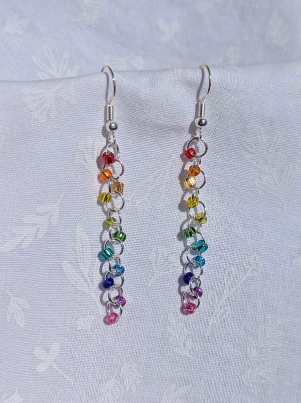 Silver Lining Rainbow earrings feature 11 different colored glass beads, all silver lined transparent. The beads are connected with silver colored jump rings.