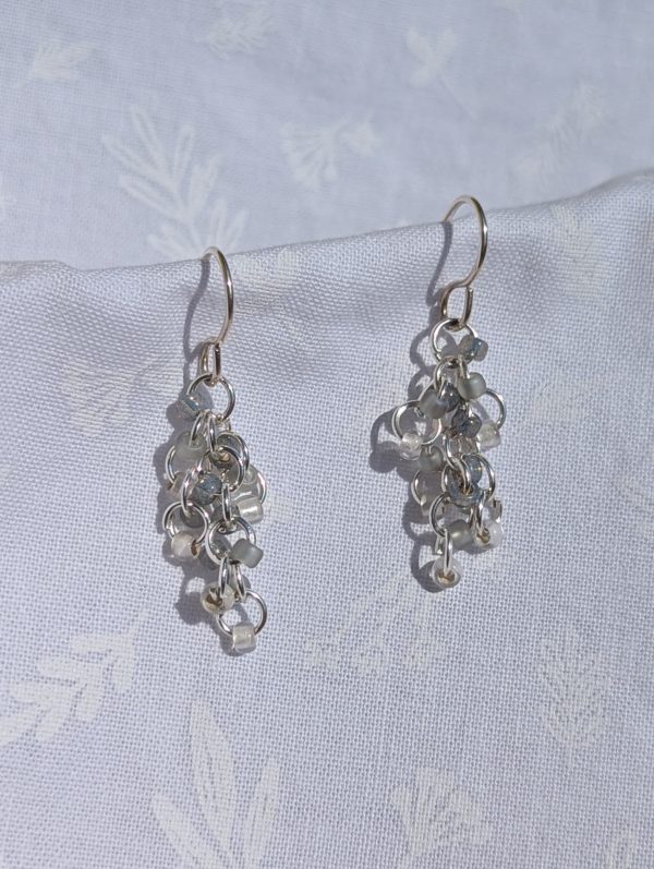 Sky's the Limit Earrings: Pale blue and clear beaded earrings with three hues and various textures, sterling silver hooks for a stylish and unique look.