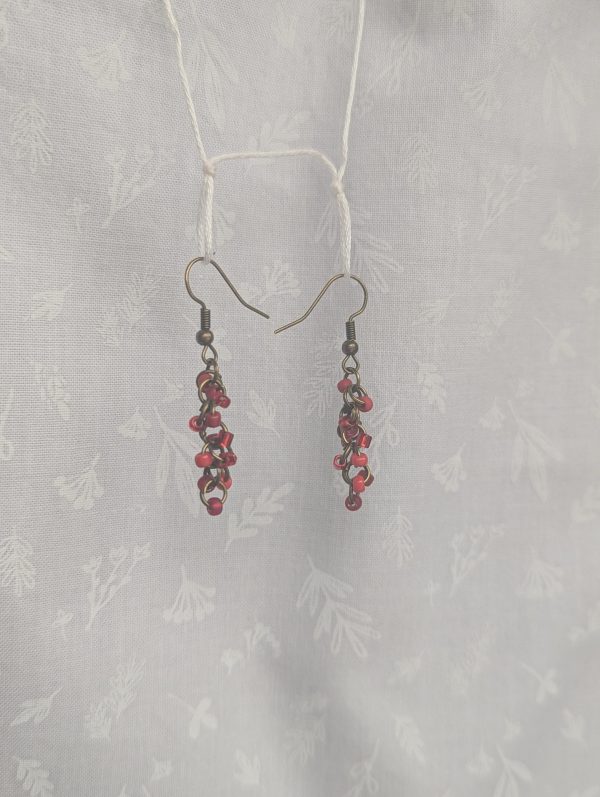 Scarlet Glow Drops: Handmade red earrings featuring six different shades of red glass seed beads, connected with bronze jump rings and matching hooks.