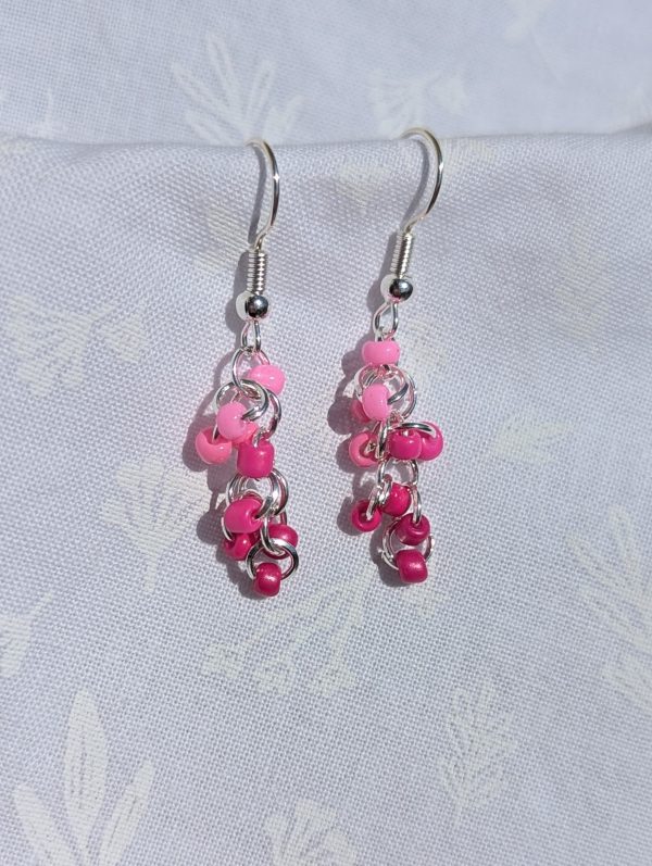 The Cotton Candy Drops Earrings are Pink earrings in five solid hues, featuring silver-colored jump rings and earring hooks for a playful and light design.