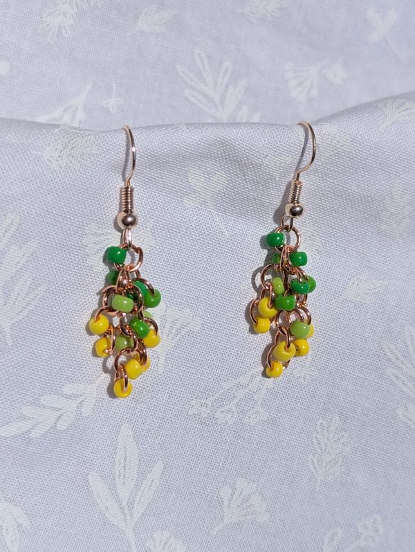 The Golden Grove Gradient Earrings feature a green and yellow gradient of glass beads, silver-colored hooks and copper jump rings.