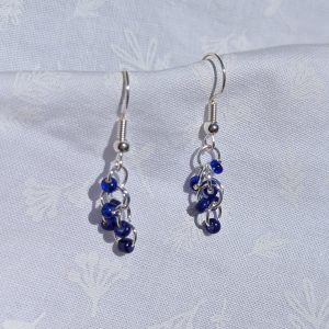 Blue Shine Earrings: Shimmering blue seed bead earrings with six blue beads, silver-colored jump rings, and sterling silver hooks.