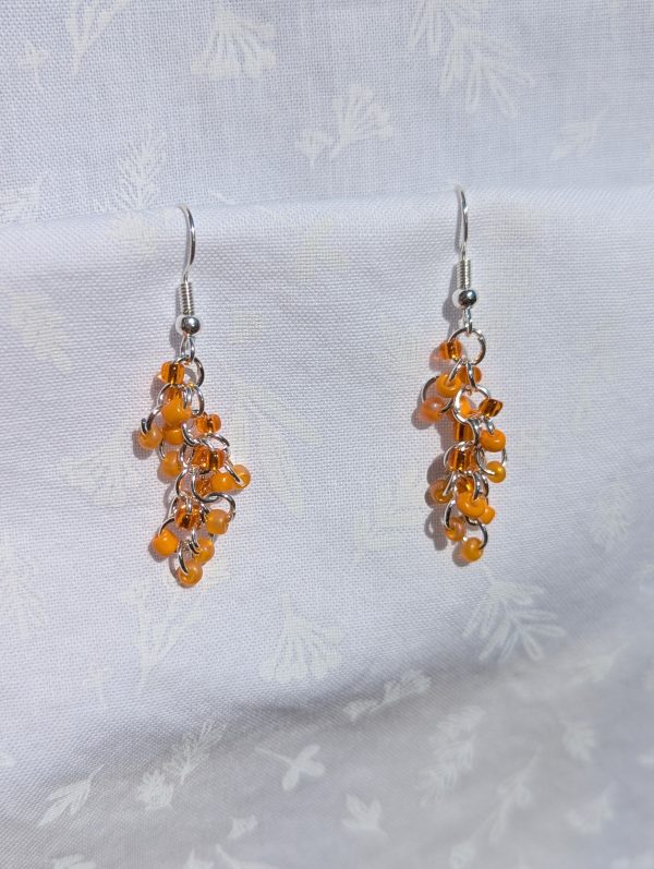 Citrus Elegance Earrings: Orange single color earrings featuring 3 hues, 18 glass seed beads per earring—six beads per shade, and silver-colored jump rings