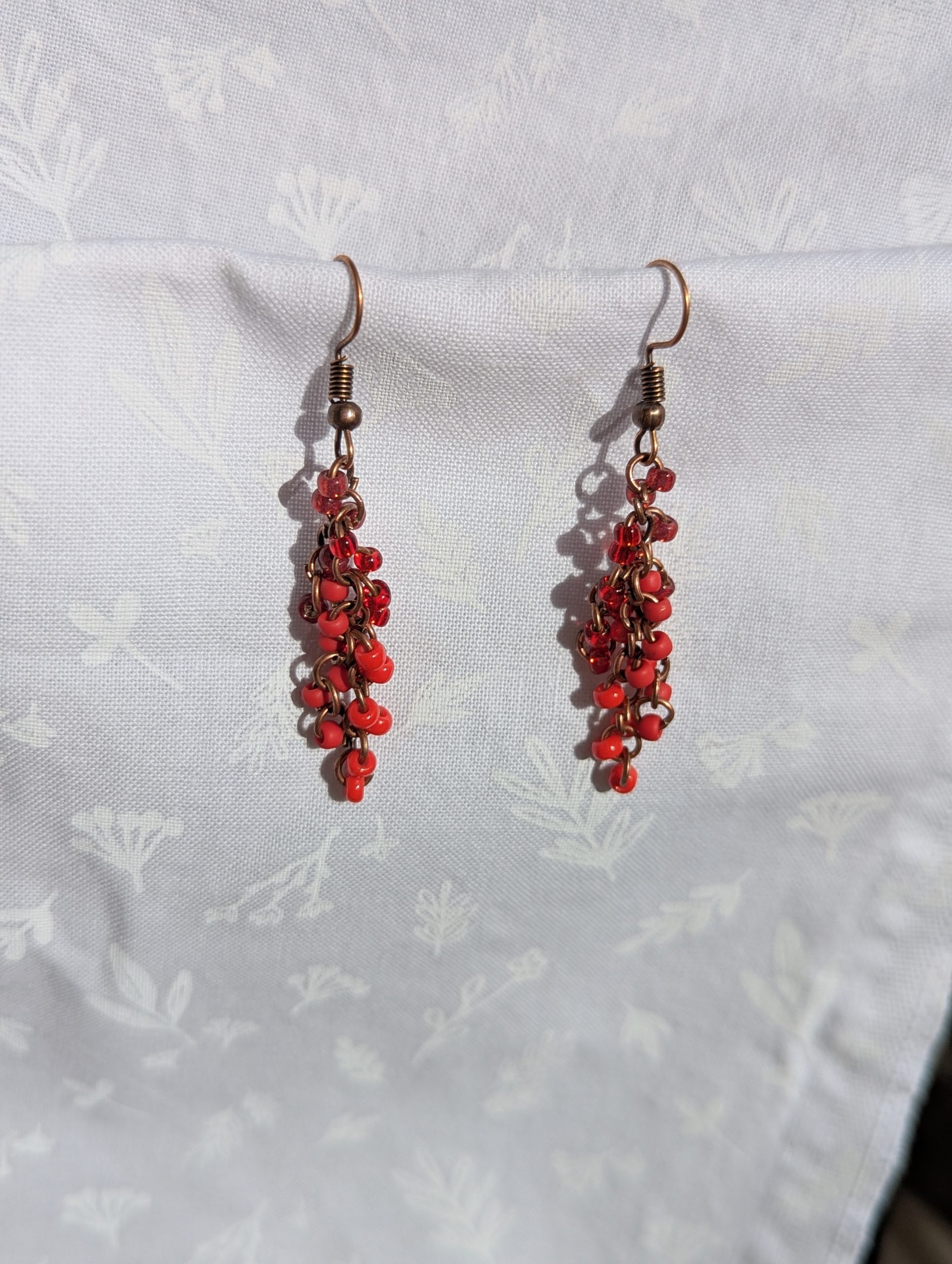 These Graceful Garnet Red earrings feature four different hues of red with various textures.