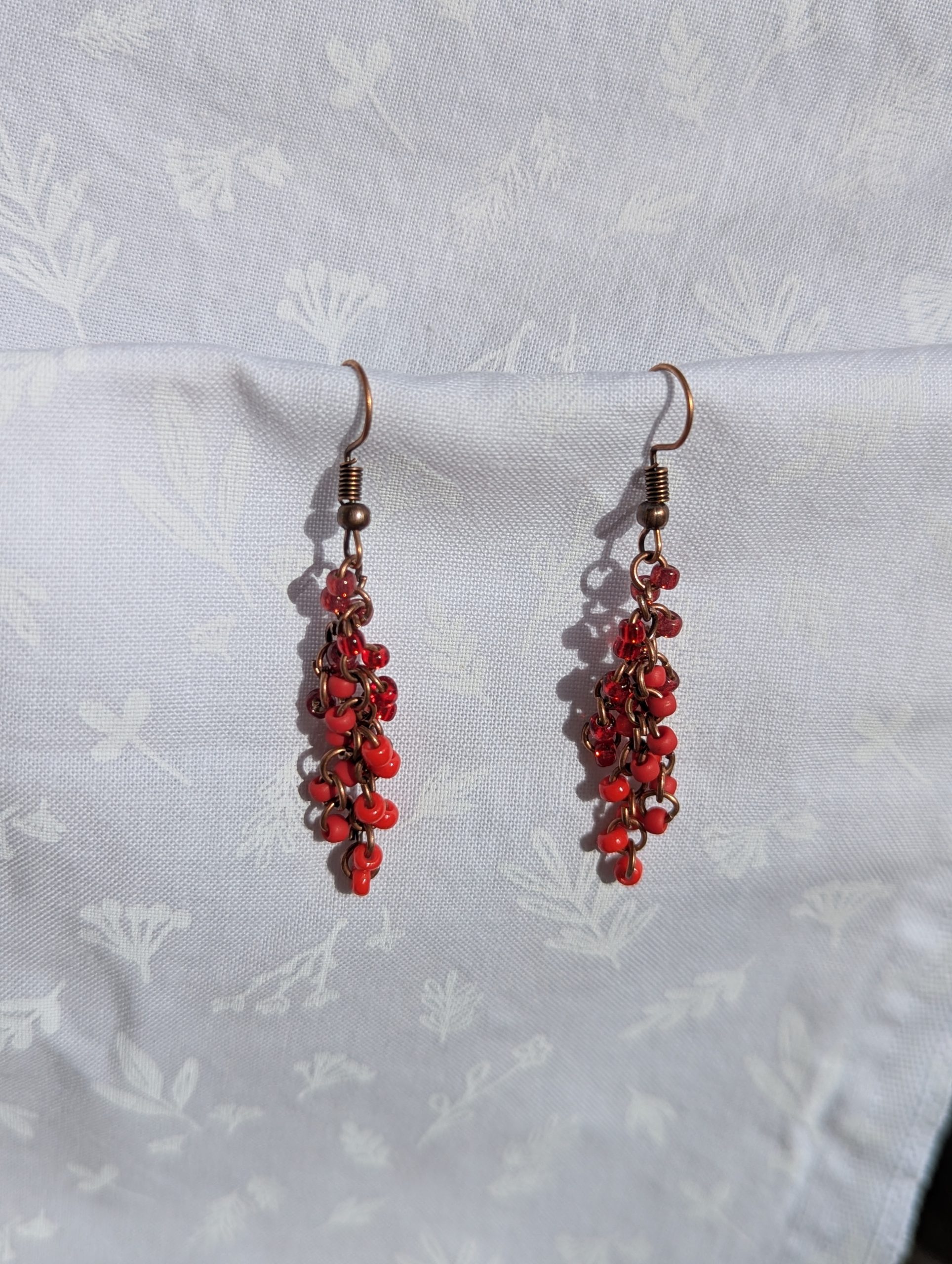 These Graceful Garnet Red earrings feature four different hues of red with various textures.