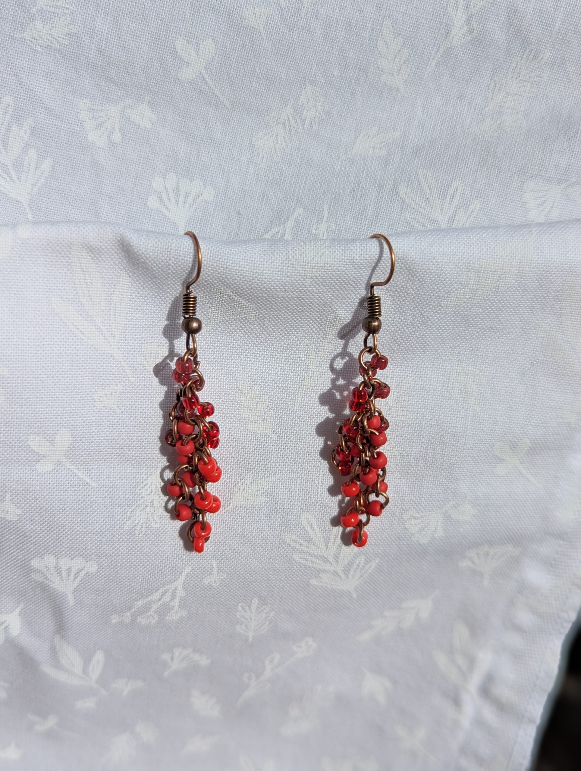 These Graceful Garnet Red earrings feature four different hues of red with various textures.