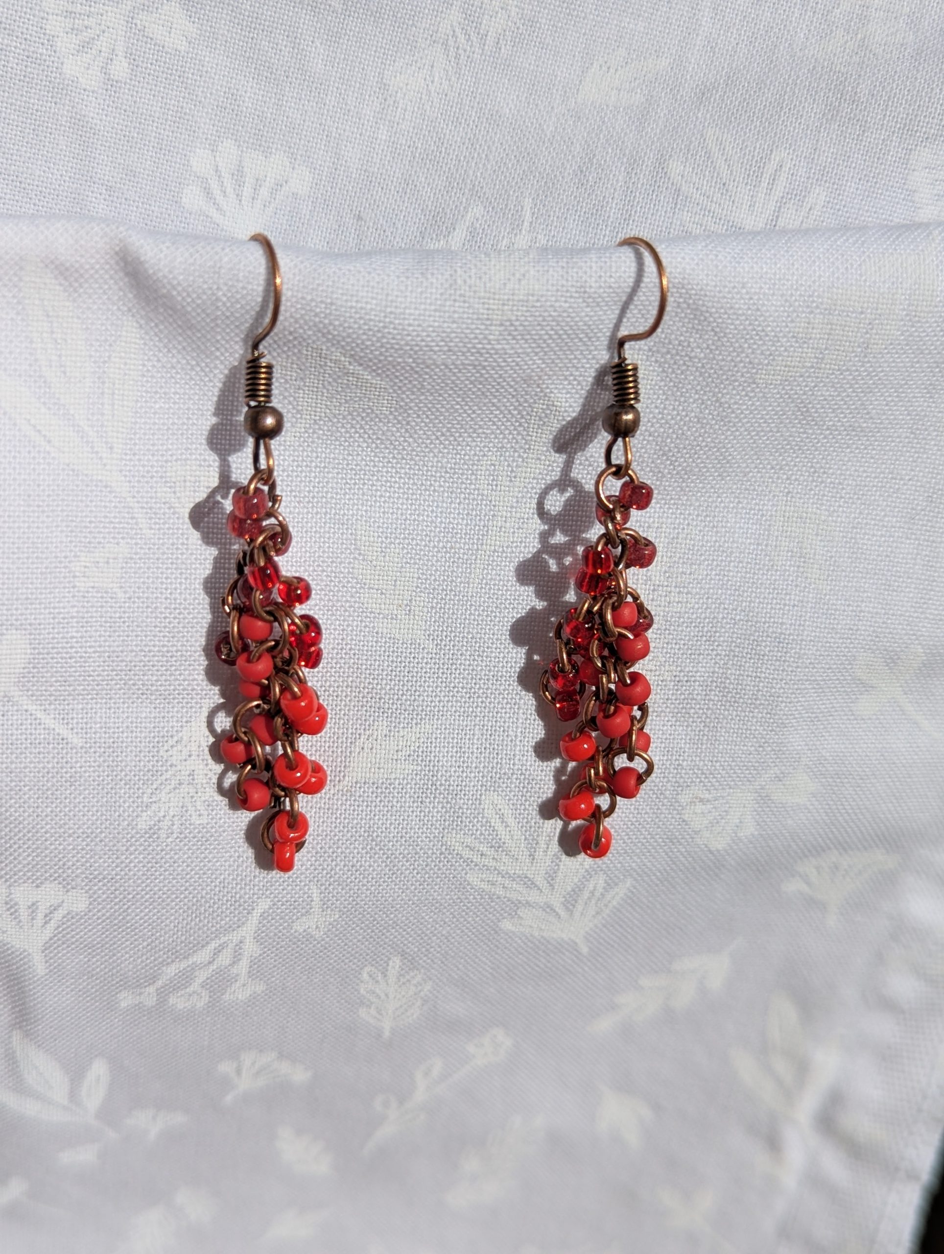 These Graceful Garnet Red earrings feature four different hues of red with various textures.