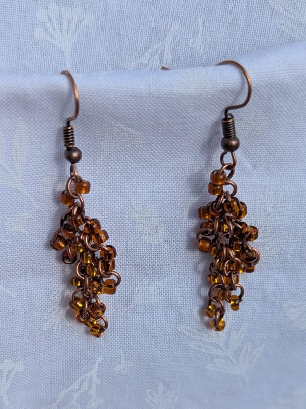 These Rustic Bronze Cascade earrings feature four slightly different hues of brown with varied textures and finishes with a total of 24 beads per earring.