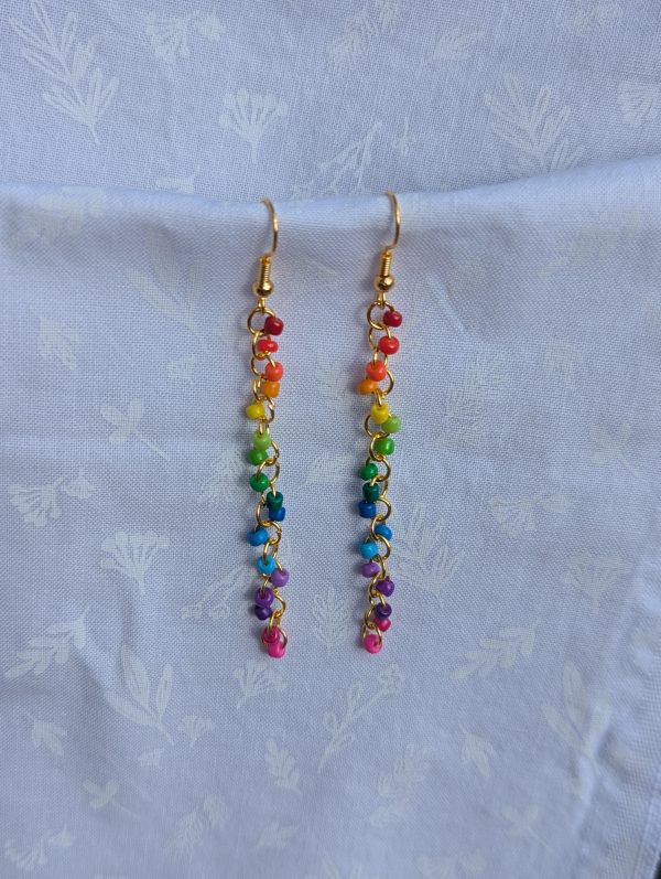 These handmade Golden Rainbow Rainbow Cascade earrings showcase a sleek, cascading design featuring 17 vibrant glass seed beads per earring.