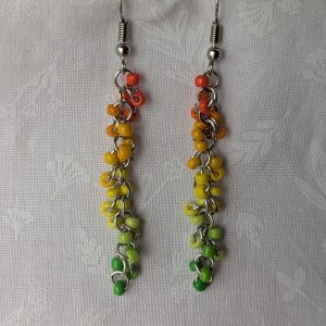 Citrus Grove Earrings: Handmade earrings with 26 solid-colored beads in a gradient from orange through yellow to green, connected by steel-colored jump rings and hooks.