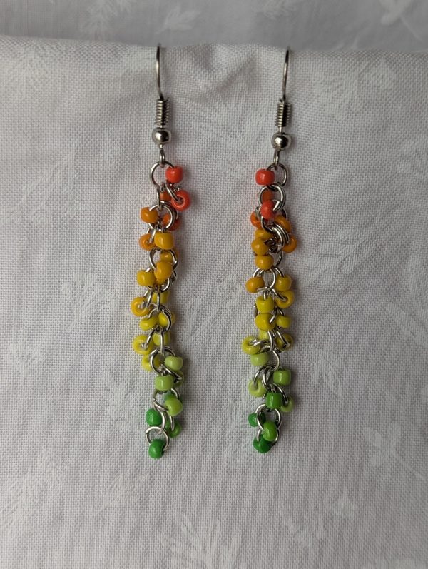 Citrus Grove Earrings: Handmade earrings with 26 solid-colored beads in a gradient from orange through yellow to green, connected by steel-colored jump rings and hooks.