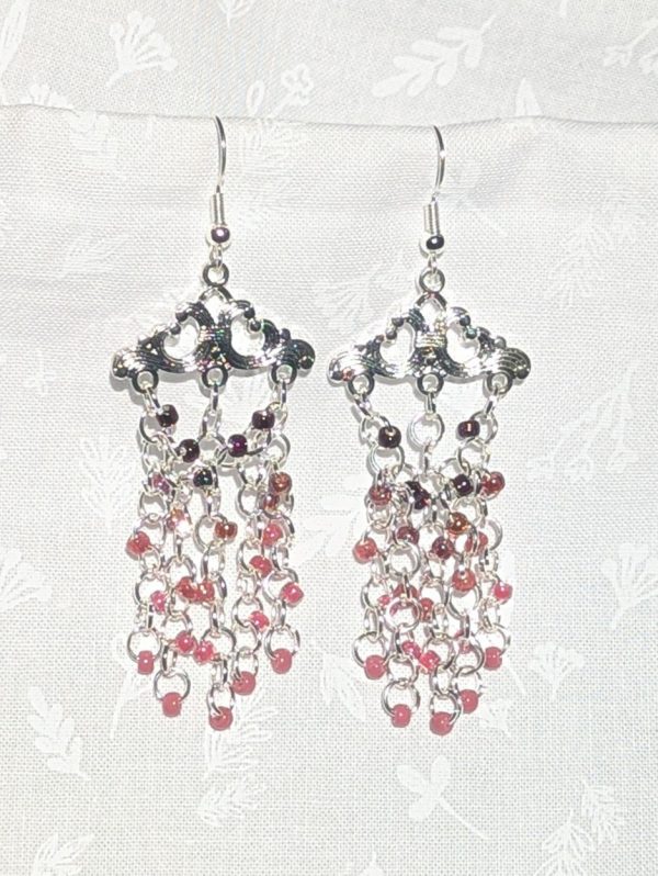 Twilight Chandelier: Chandelier-style earrings featuring 25 mauve and garnet-toned beads in a silver Tibetan-style frame with matching silver hooks.