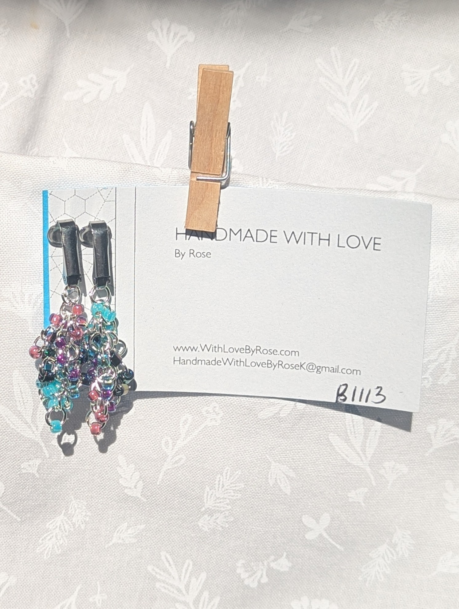 Mermaid Dreams: Clip-on earrings with 30 beads in shimmering oceanic colors including aqua, indigo, and pink, connected with silver jump rings.