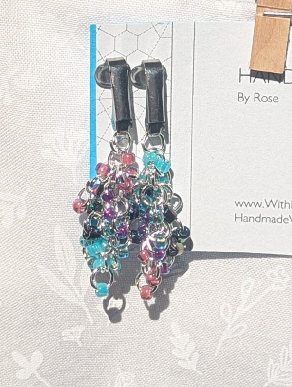 Mermaid Dreams: Clip-on earrings with 30 beads in shimmering oceanic colors including aqua, indigo, and pink, connected with silver jump rings.