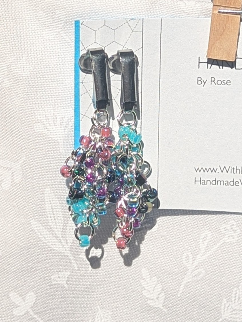 Mermaid Dreams: Clip-on earrings with 30 beads in shimmering oceanic colors including aqua, indigo, and pink, connected with silver jump rings.