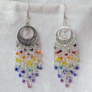Celestial Rain earrings with colorful rainbow beads cascading from ornate silver celestial ornaments, connected with silver jump rings and earring hooks.