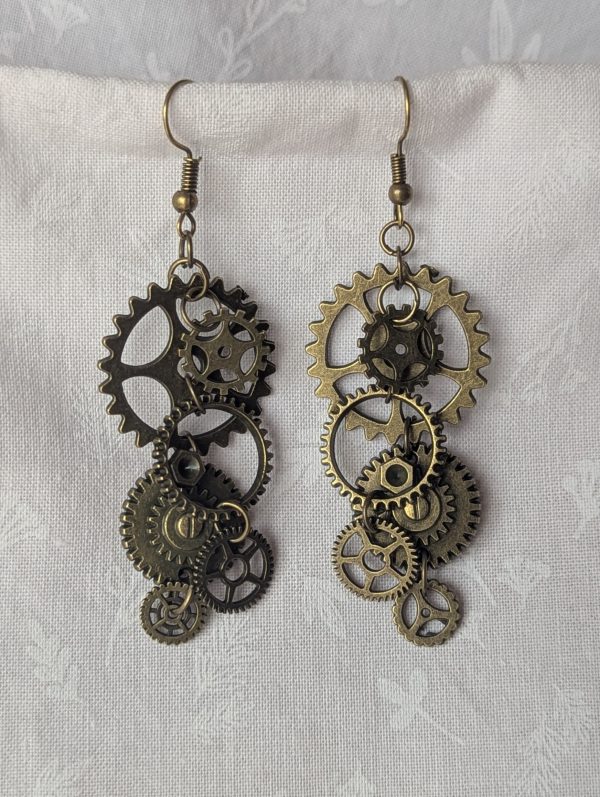 The Clockwork Dreams Earrings: bronze gear earrings featuring six metal gears linked with bronze jump rings and matching bronze earring hooks.