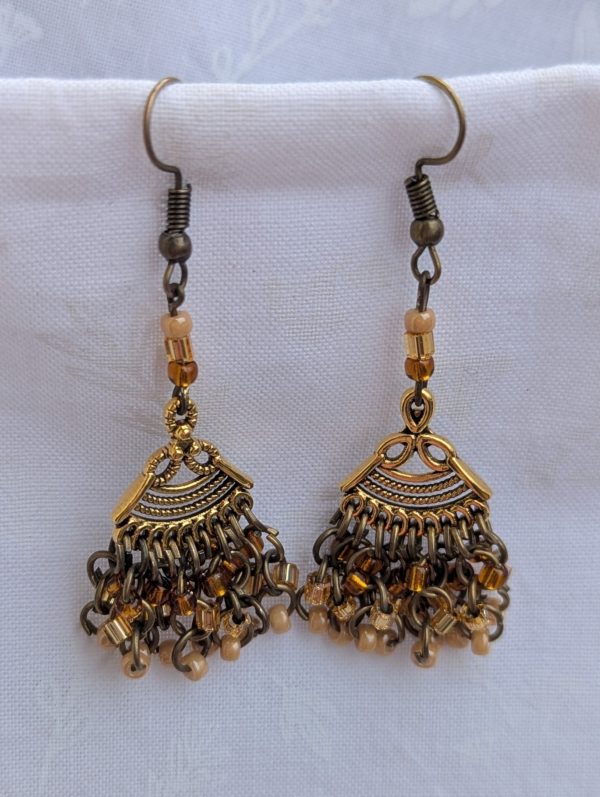 Desert Dusk Earrings: Antiqued gold chandelier-style earrings with 30 beads in silver-lined brown, silver-lined tan, and pearly beige, finished with bronze-colored hooks.