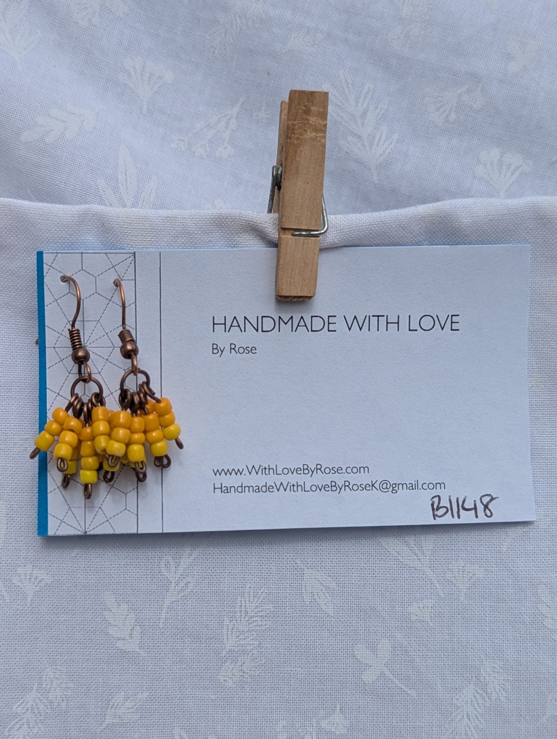 Sunburst Petals Earrings: Yellow beaded earrings with 24 beads in golden tones—marigold, honey, and lemon—hung from bronze posts with matching hooks.