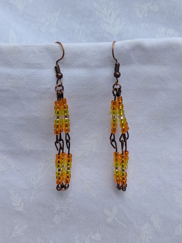 Citrus Mirage Earrings—Gradient earrings with 42 silver-lined beads each, transitioning from orange to yellow to white and back, connected with bronze-colored findings.