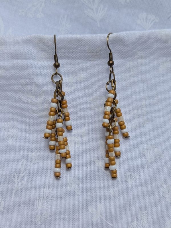 Sandswept Glow — Earrings with earthy tan, ivory white, and pearlescent cream glass beads on bronze-toned posts and hooks.