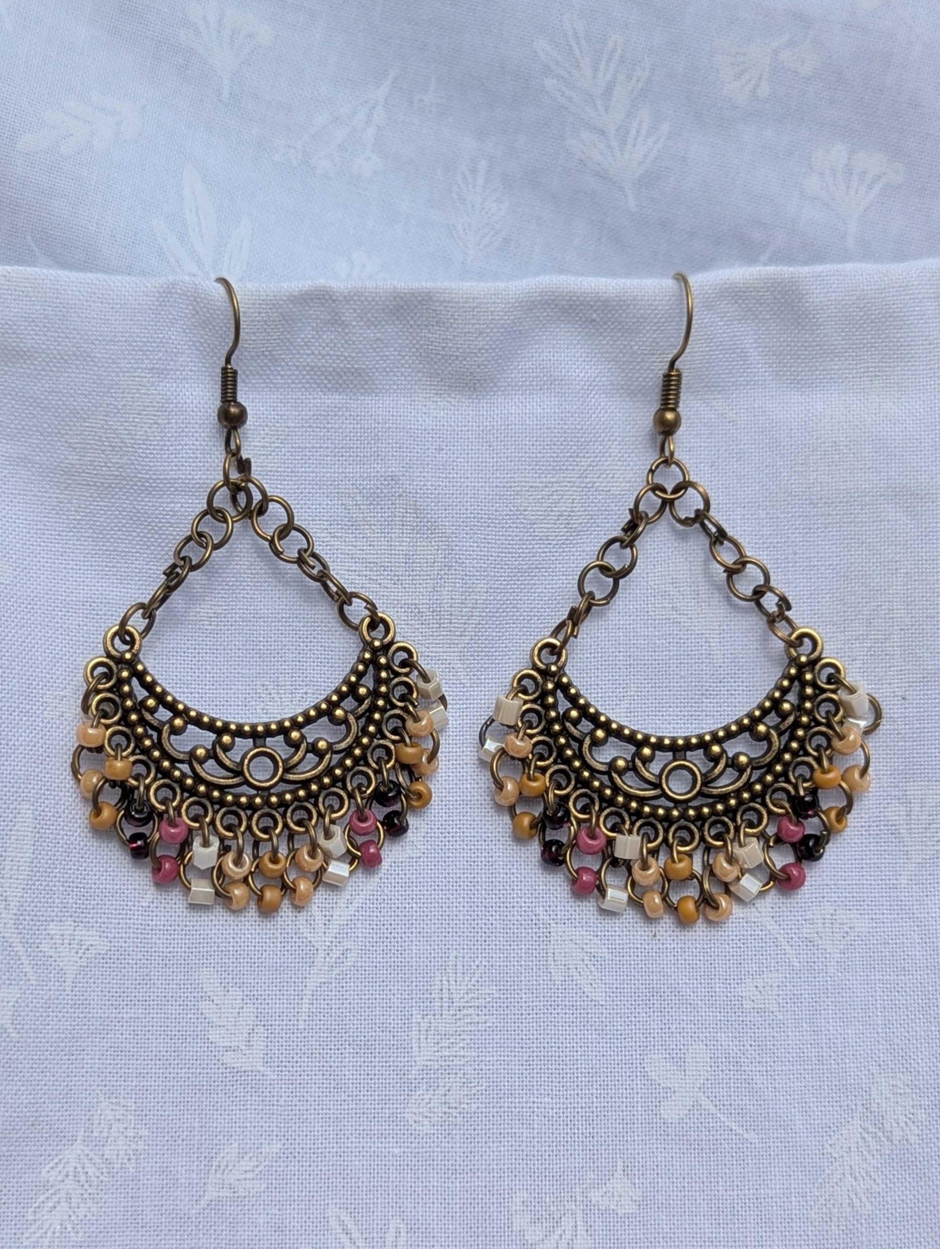 Desert Bloom Earrings: Tibetan-style bronze earrings with 30 glass beads in earthy tan, pearly beige, rose, wine red, and pearly cream.
