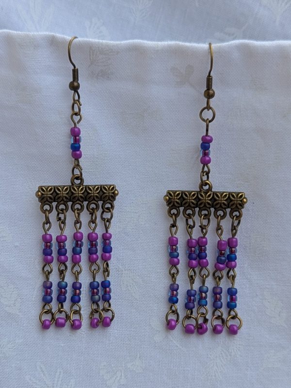Festival of Lights — Bronze-tone earrings with floral Tibetan-style bars and five dangling strands of fuchsia, orchid pink, and sapphire blue glass beads.