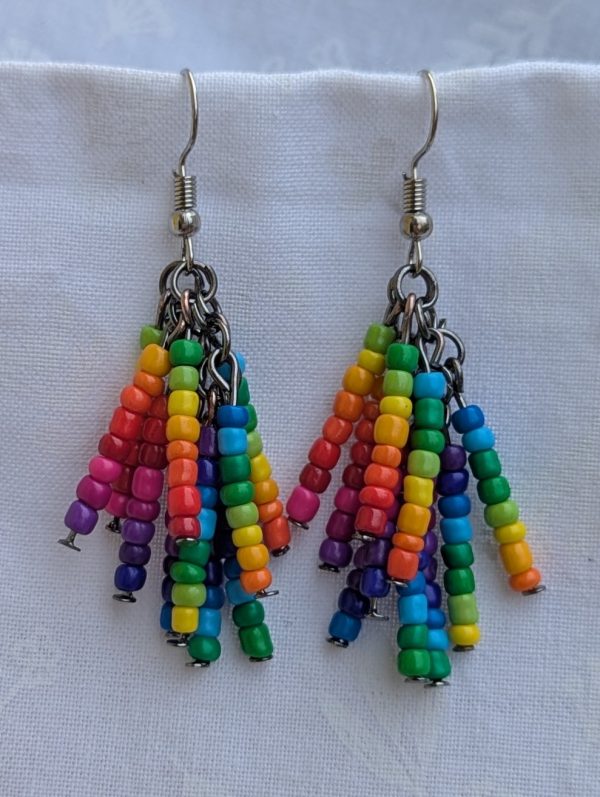 Rainbow Glow Drop Earrings: Vibrant rainbow dangle earrings with glossy multicolor seed beads arranged in cascading clusters on tungsten and steel findings.