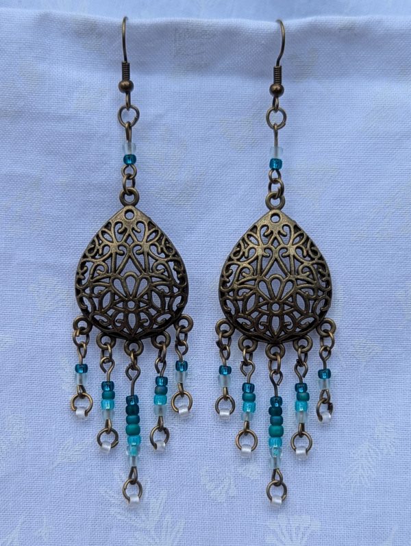 Ocean Lace Earrings; Bronze teardrop earrings with teal gradient beads from dark green to white.