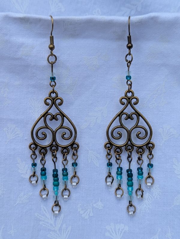 Tidal Filigree Earrings: bronze earrings with teal gradient beaded strands from dark to light.