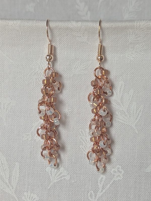 Rosy Lumina Earrings with 27 blush pink, pearly white, and translucent rose beads on copper jump rings with rose-gold earring hooks.