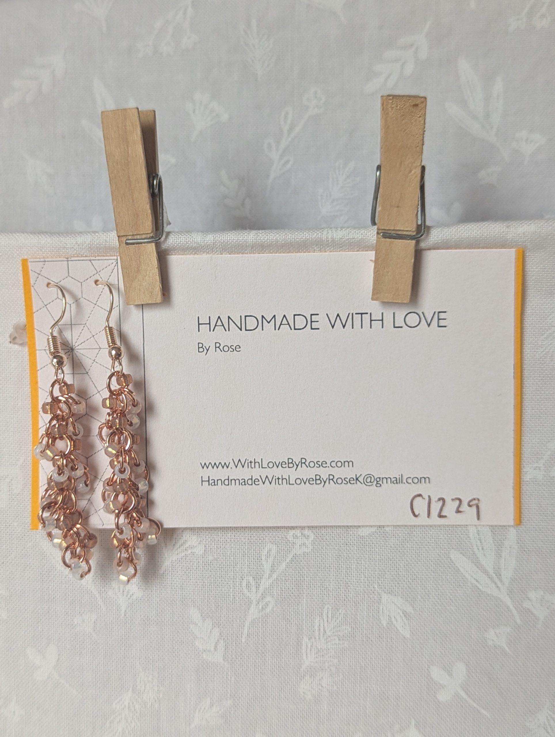 Rosy Lumina Earrings with 27 blush pink, pearly white, and translucent rose beads on copper jump rings with rose-gold earring hooks.