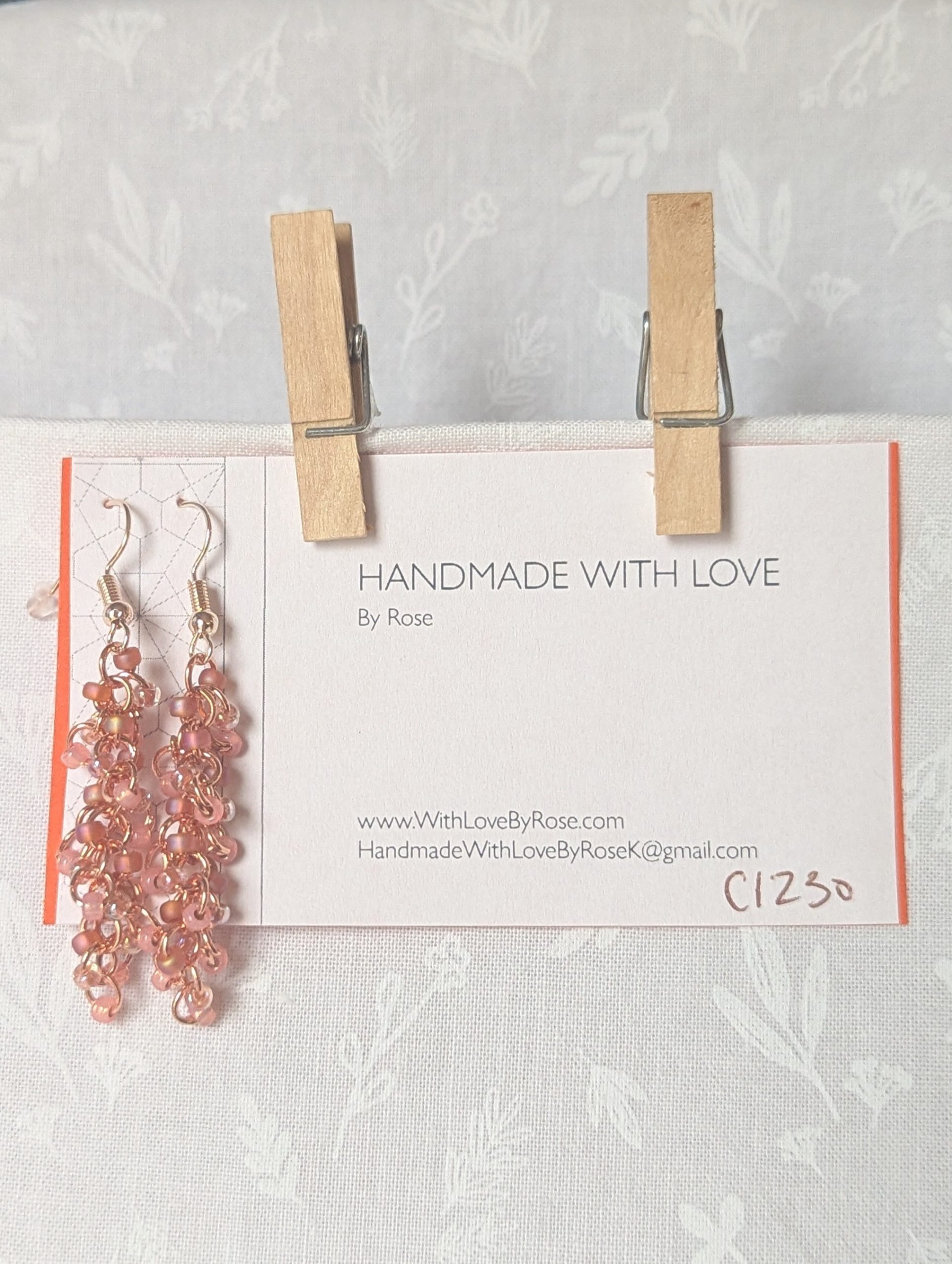 Blush Bloom Earrings with 27 soft pink glass beads in matte, translucent, and iridescent finishes, on copper rings with rose-gold earring hooks.