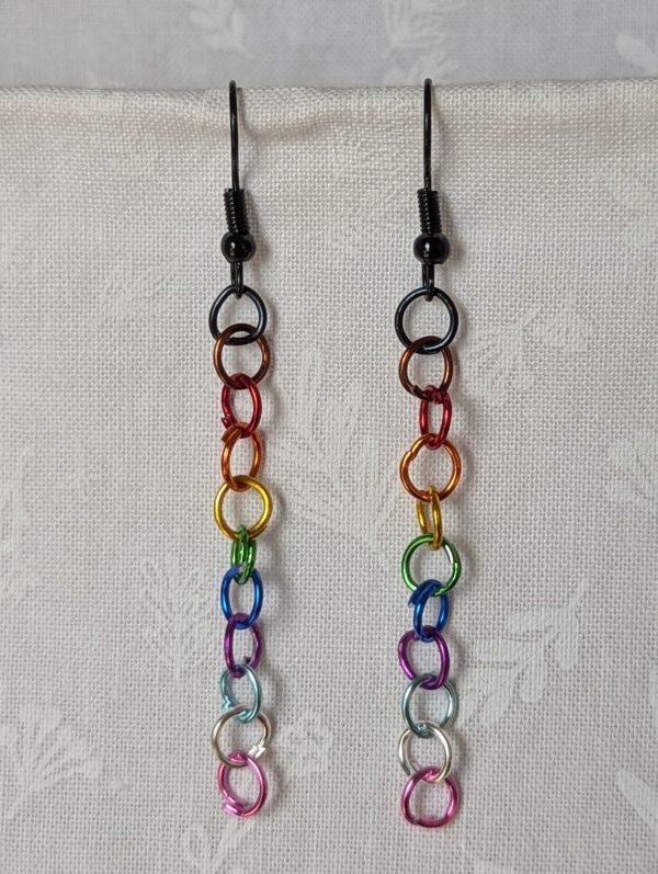 Unity in Color Earrings featuring 11 symbolic glass beads and matching rainbow jump rings in BLM, Pride, and Trans flag colors, with black earring hooks.