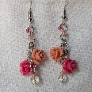 Handmade blush rose cascade earrings with coral and pink roses, glass seed beads, and crystal accents on steel colored hooks.