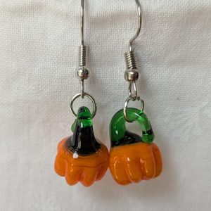 Handmade autumn pumpkin earrings with amber-orange glass pumpkin beads, green accents, and steel-colored findings.