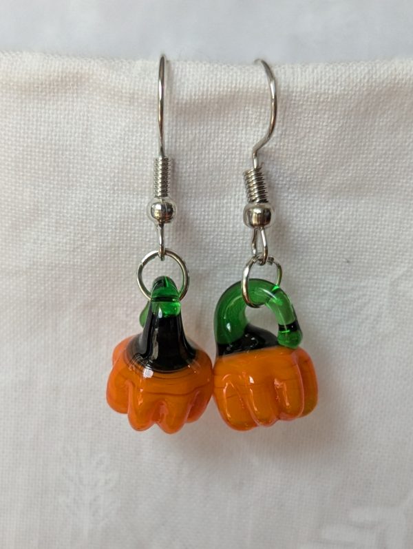 Handmade autumn pumpkin earrings with amber-orange glass pumpkin beads, green accents, and steel-colored findings.