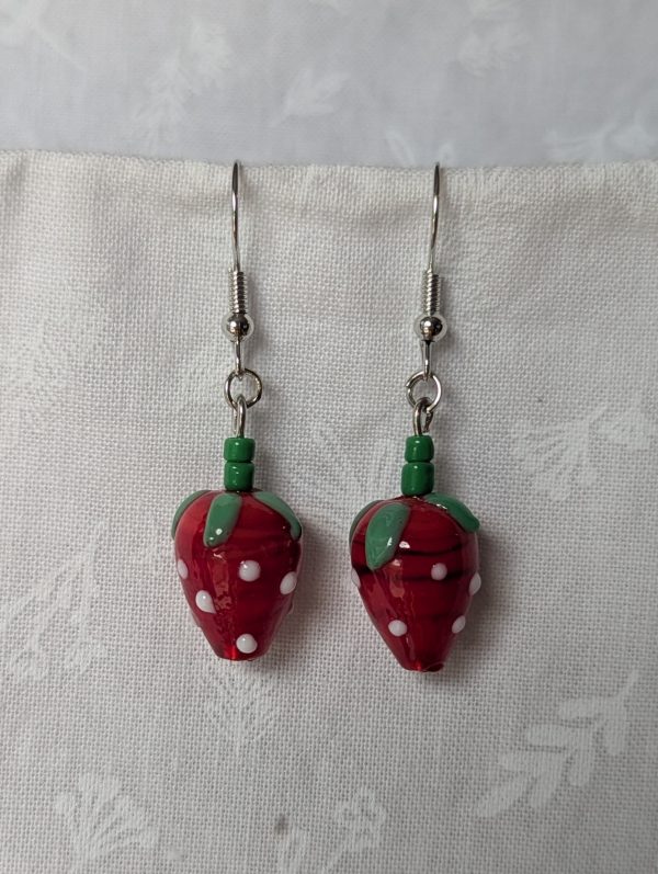 Handmade glass sweet strawberry earrings with red, green, and white details on steel hooks