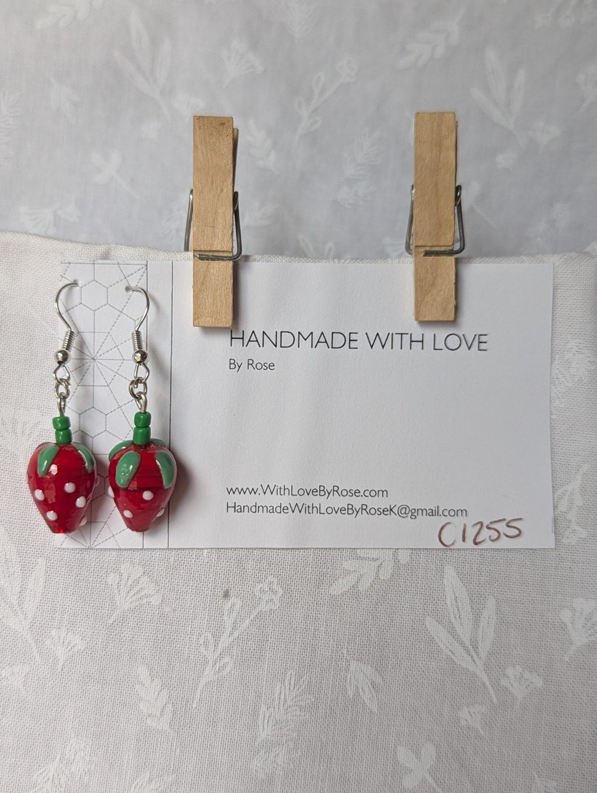 Handmade glass sweet strawberry earrings with red, green, and white details on steel hooks