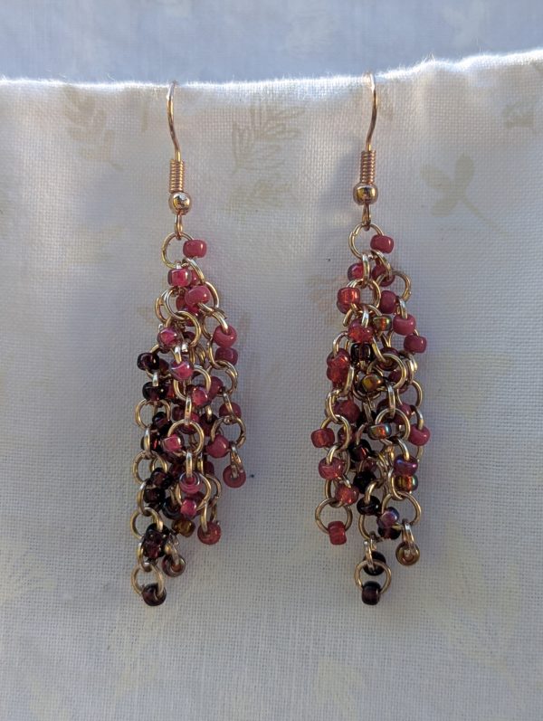 Handmade pink beaded earrings with 45 glass seed beads in deep pink shades, linked with rose-gold jump rings and hooks.
