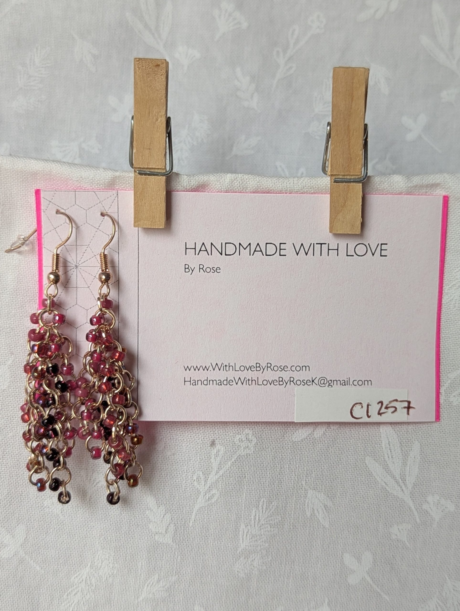 Handmade pink beaded earrings with 45 glass seed beads in deep pink shades, linked with rose-gold jump rings and hooks.