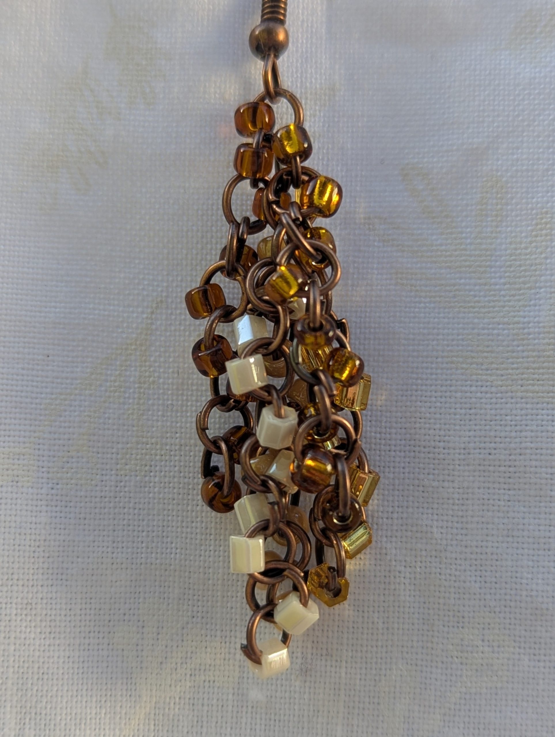 Autumn Cascade Earrings: Handmade brown beaded earrings with 45 glass beads in warm fall shades of amber, cream, bronze, and espresso.
