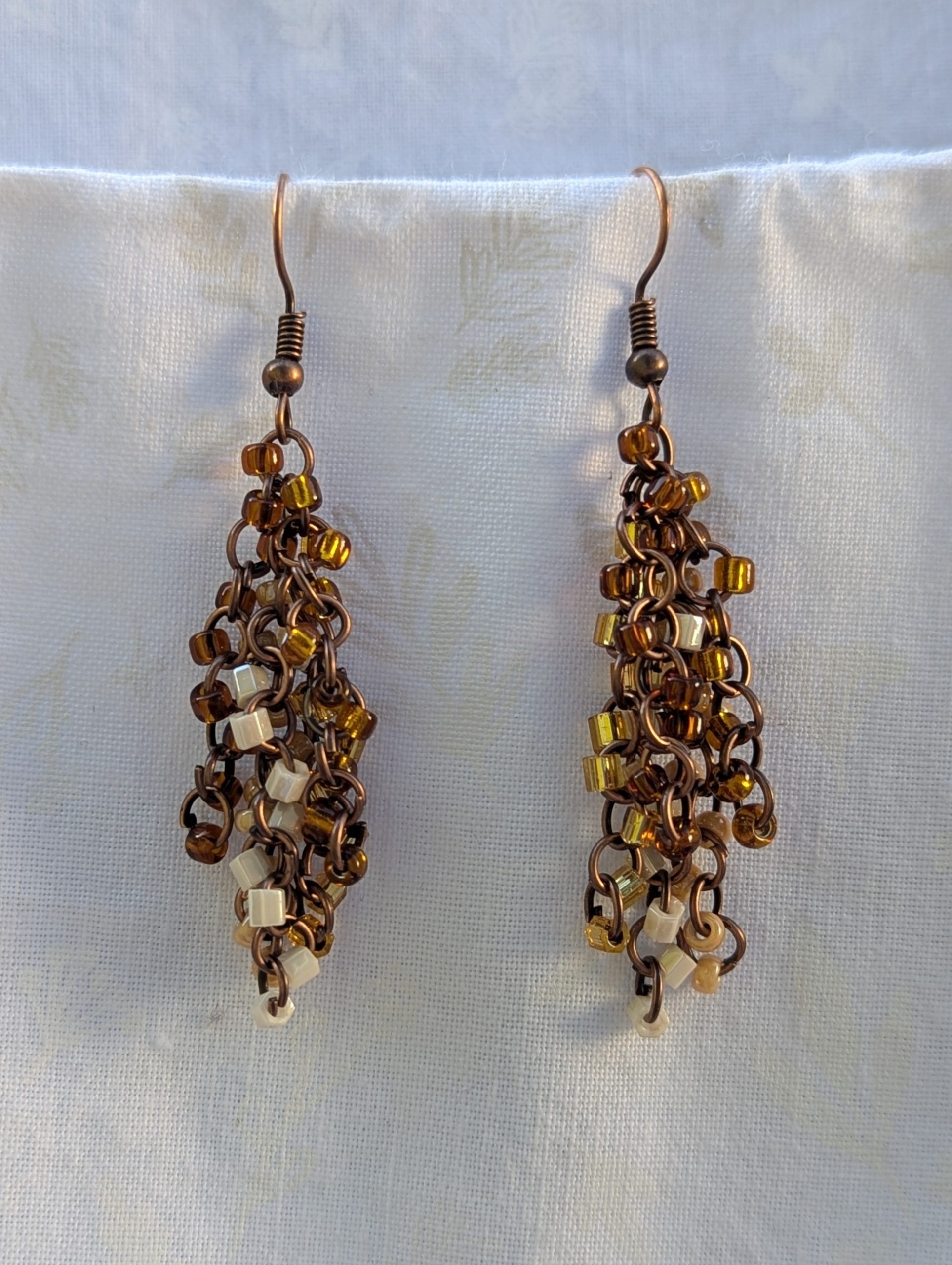 Autumn Cascade Earrings: Handmade brown beaded earrings with 45 glass beads in warm fall shades of amber, cream, bronze, and espresso.