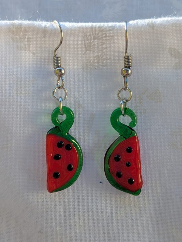 Handmade glass watermelon slice earrings with pink-red centers, green rinds, and sterling silver hooks.