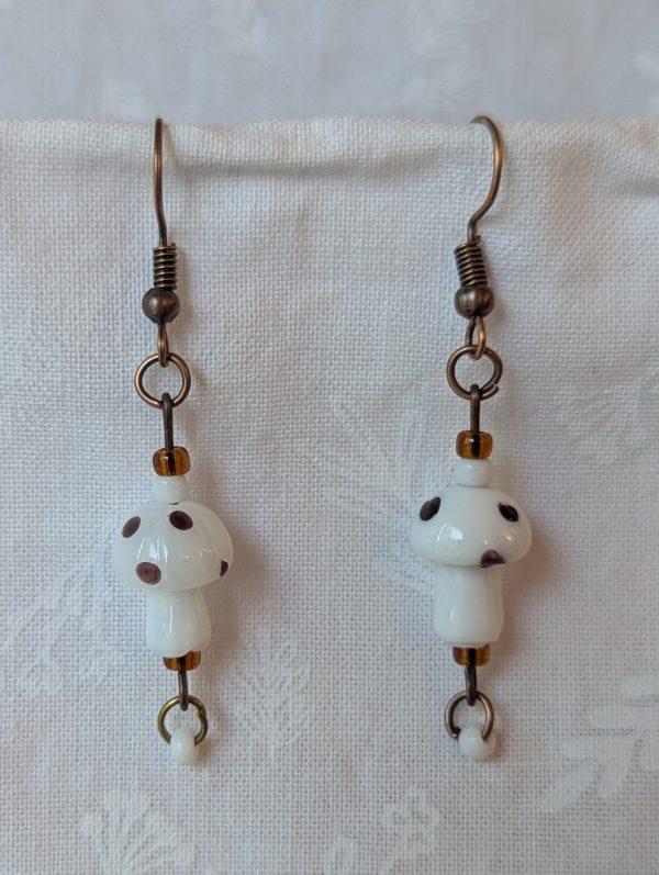 Handmade white and brown mushroom earrings with glass toadstools, white and deep brown seed beads, and bronze-colored hooks