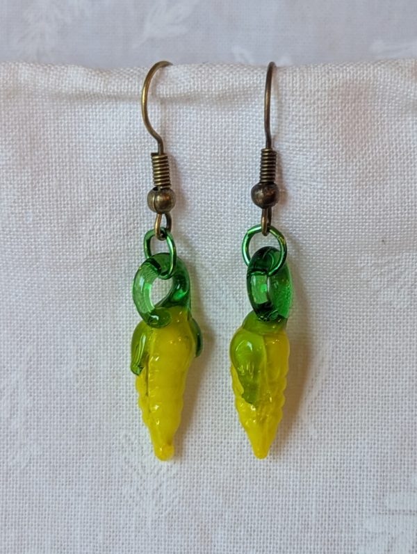 Handmade corn earrings featuring yellow and green glass corn beads with bronze jump rings and hooks.