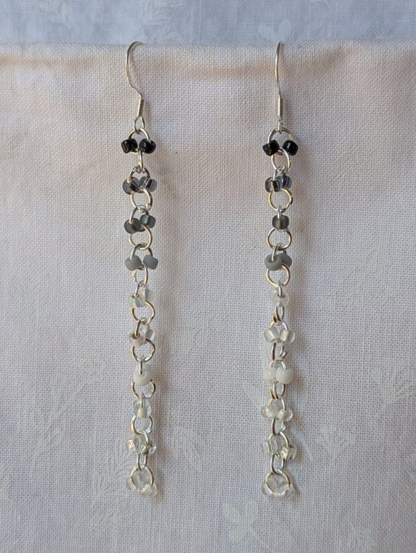 Handmade black and white gradient earrings with 20 glass beads connected by silver metal links and sterling silver hooks.