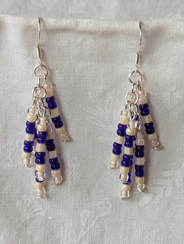 Handmade blue and cream beaded earrings with silver connectors and sterling silver hooks, featuring cascading strands of seed beads.