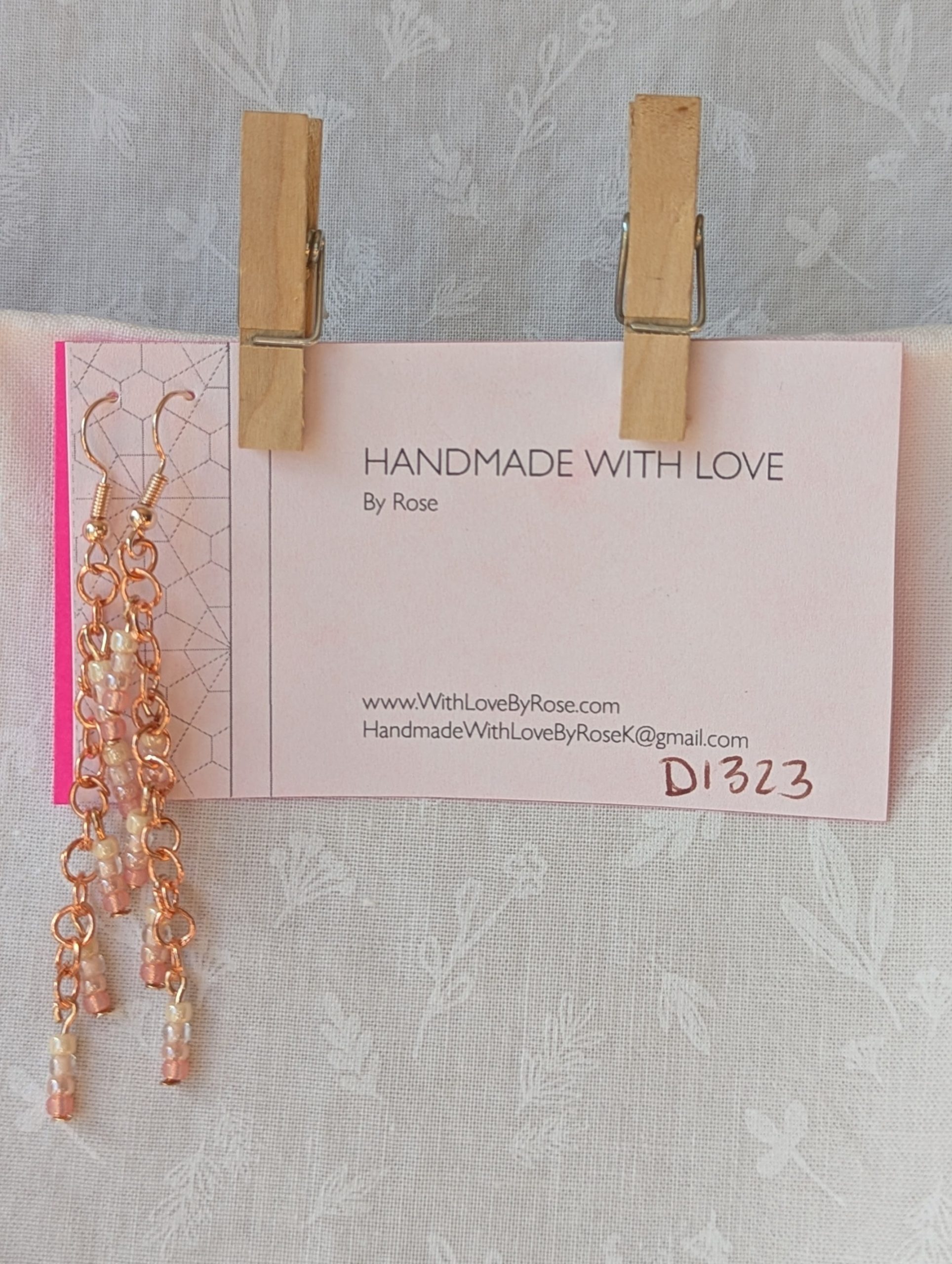 Handmade blush cream beaded earrings featuring pale pink and cream glass beads in four shades, linked with copper jump rings and rose-gold hooks.