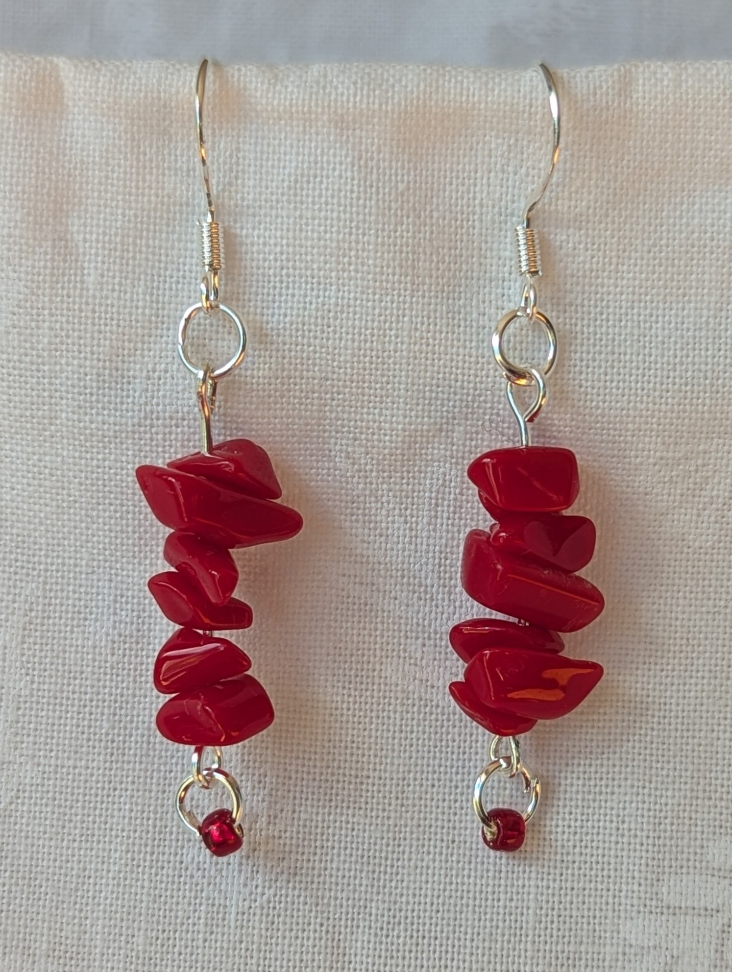 Handmade scarlet stone cascade earrings with red gemstone chips and small glass seed beads on sterling silver hooks.
